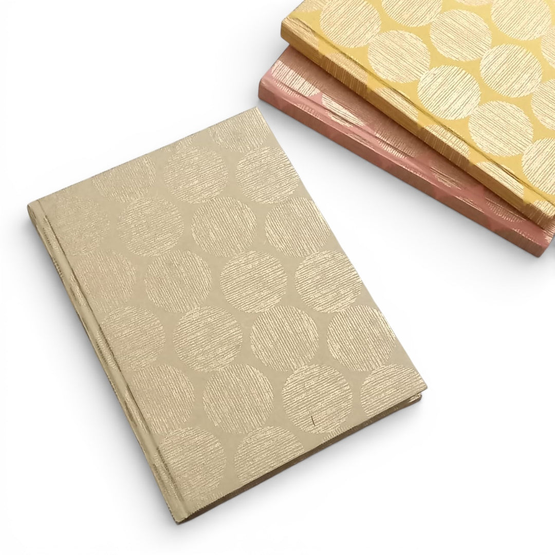 Hardbound Notebooks sustainably made with handmade paper, patterned with the Gifts of Love Hinode design laying flat on a white background.