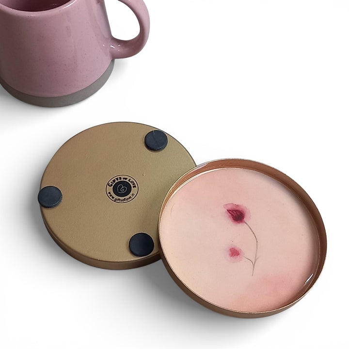 Round enamel coaster with floral design on a white background