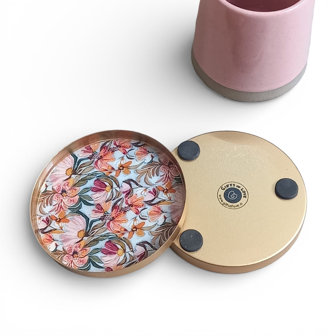 Round floral coaster with a gold rim on a white background