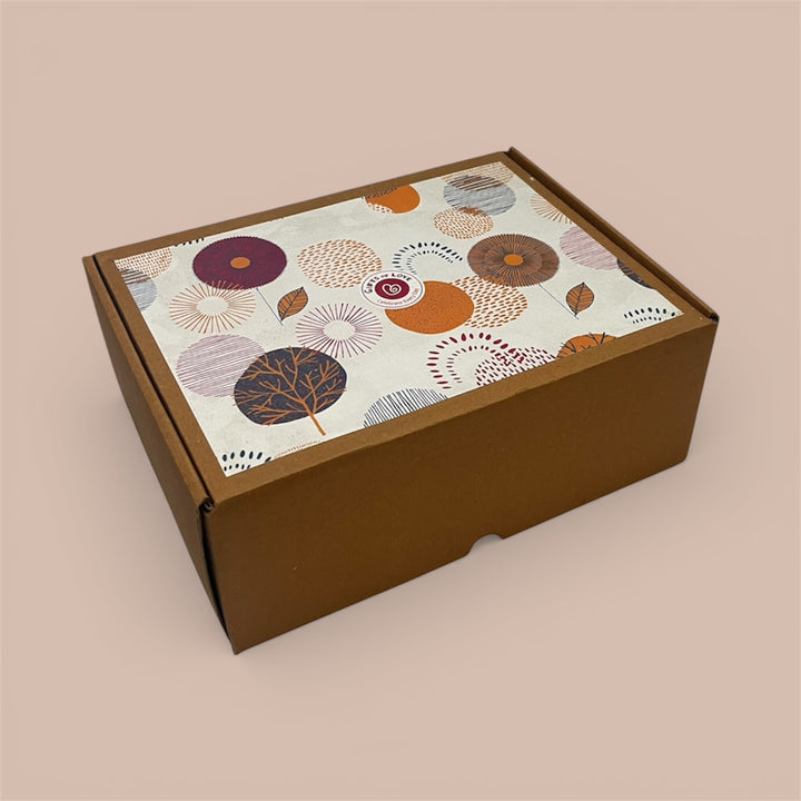 Outer brown cardboard box with a decorative floral pattern on a beige background