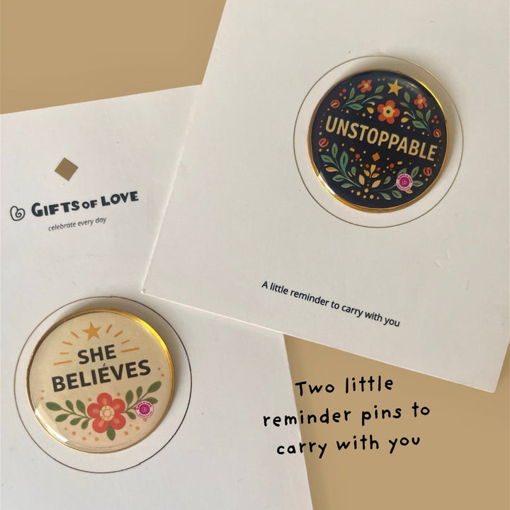 Two motivational pins on cards on a beige background.