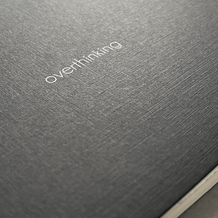 Textured paper with ‘overthinking’ screen printed on the cover. 